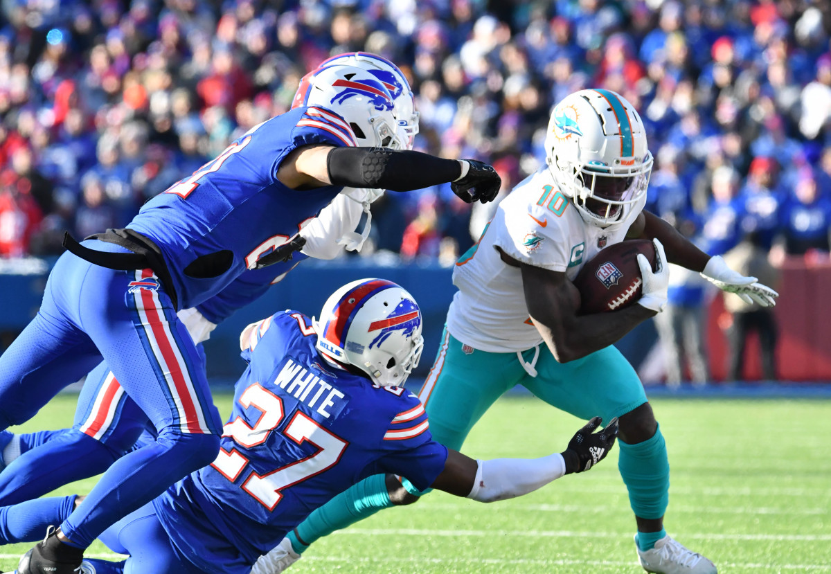 Miami Dolphins wide receiver Tyreek Hill (10) tries to get away from Buffalo Bills cornerback Tre'Davious White (27) and safety Jordan Poyer (21) and cornerback Taron Johnson (7)